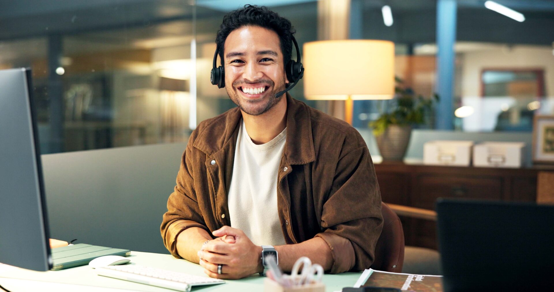 Portrait, headset or happy man with computer for customer care, help desk or troubleshooting contact. Online advice, tech support or virtual assistant with pride for solution, hotline or call center