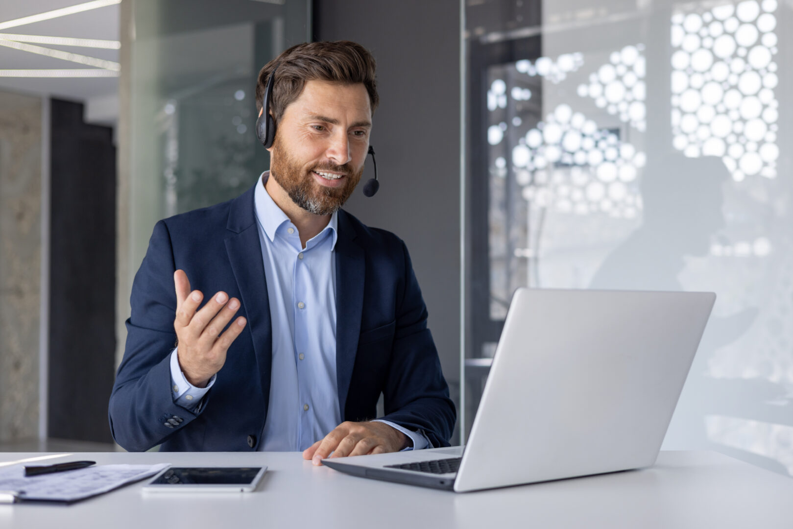Confident businessman giving online presentation from office